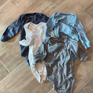 Four long sleeved baby onesies